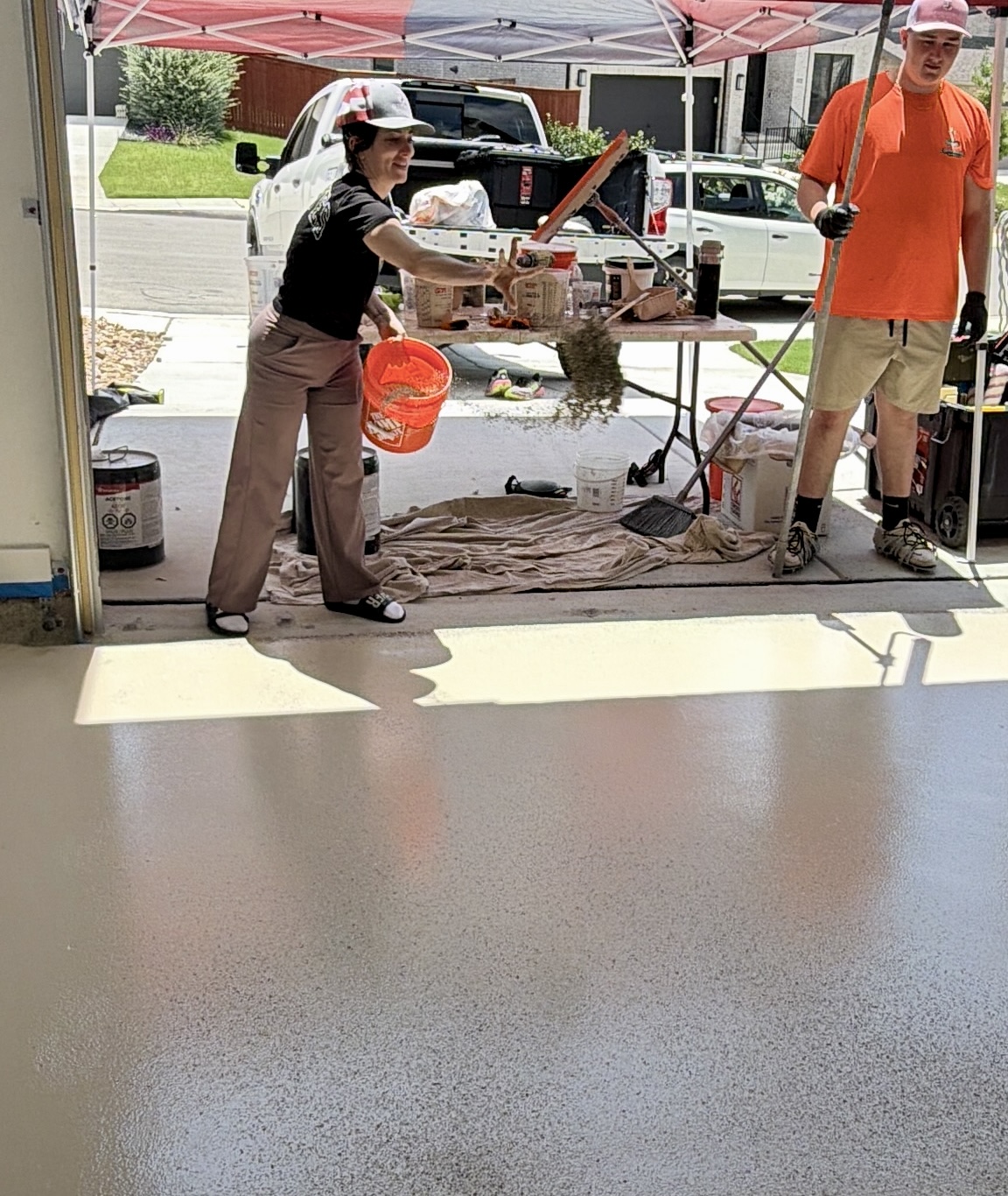 Cornerstone Epoxy crew member broadcasting flakes during an install