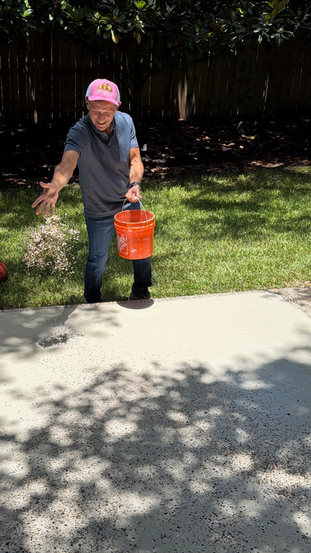 Customer broadcasting flake on a freshly coated patio